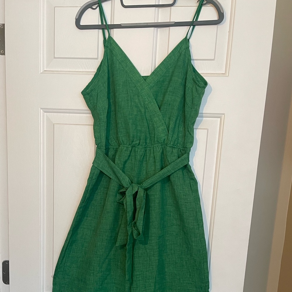 Green jumpsuit with open back design